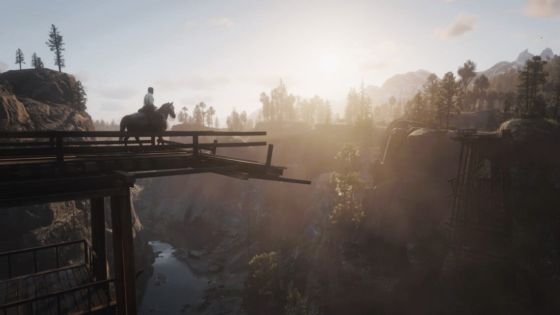 Arthur Morgan on a rose gray Andalusian horse walking on Bacchus Bridge. The bridge is broken and Arthur and the horse are walking towards the break. Across the bridge, the sun sets. We can see the Dakota River below them.