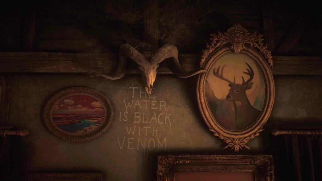 The interior of the cabin at Bayall Edge. "The Water is Black with Venom" is painted onto the wall under a ram's skull.