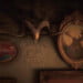 The interior of the cabin at Bayall Edge. "The Water is Black with Venom" is painted onto the wall under a ram's skull.