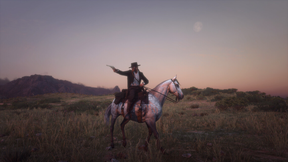 Arthur Morgan on a dapple gray Thoroughbred in a meadow. He points a revolver at someone out of frame. Behind him, the moon is beginning to appear as the sun goes down.