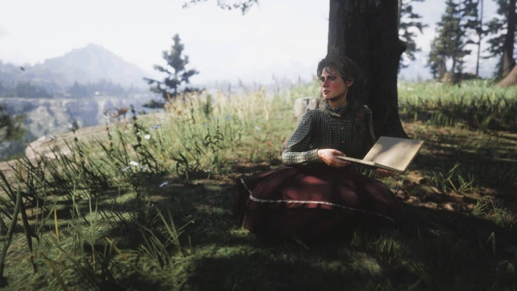 Mary-Beth Gaskill holding a book at Horseshoe Overlook. She's looking off to the side.