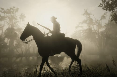 Arthur Morgan on a Turkoman horse near Bayou Nwa. He holds a rifle. The sun is rising behind him.
