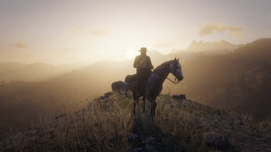 Arthur Morgan on a rose gray Andalusian horse on a hillside. He holds a sidearm and wears a black hat and coat. He's looking to the side. Behind him, the sun sets.
