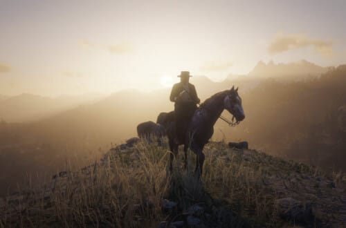Arthur Morgan on a rose gray Andalusian horse on a hillside. He holds a sidearm and wears a black hat and coat. He's looking to the side. Behind him, the sun sets.