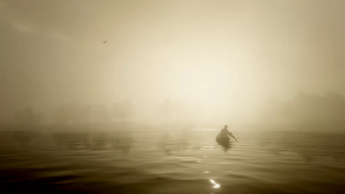 Arthur Morgan paddling a canoe on Flatiron Lake at sunset.