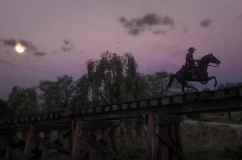 John Marston galloping over a railroad bridge under the rising moon.